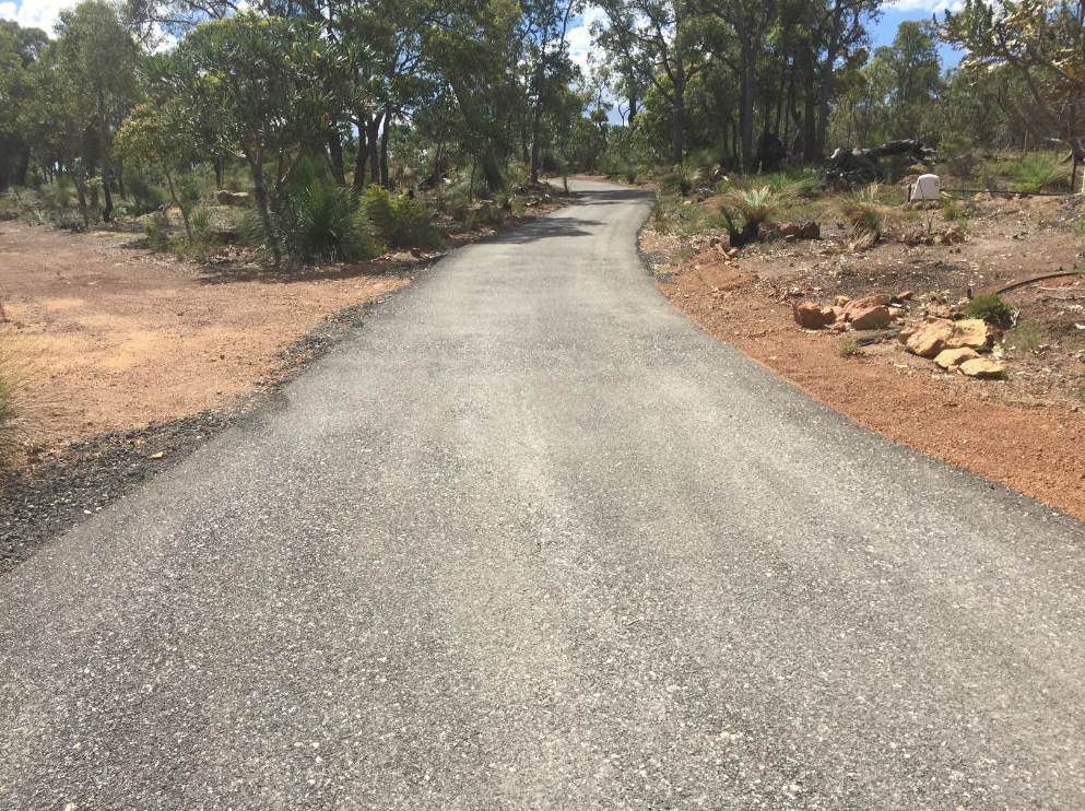 This is a photo of a hot spray & seal bitumen driveway which is in the process of being installed by Dandenong South Road Tech